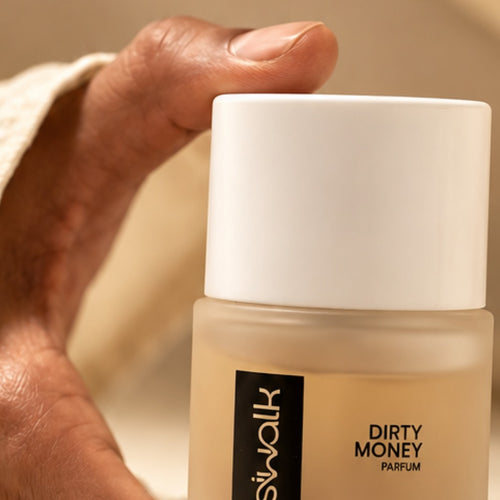 Dirty Money 50ml parfum bottle held in hand
