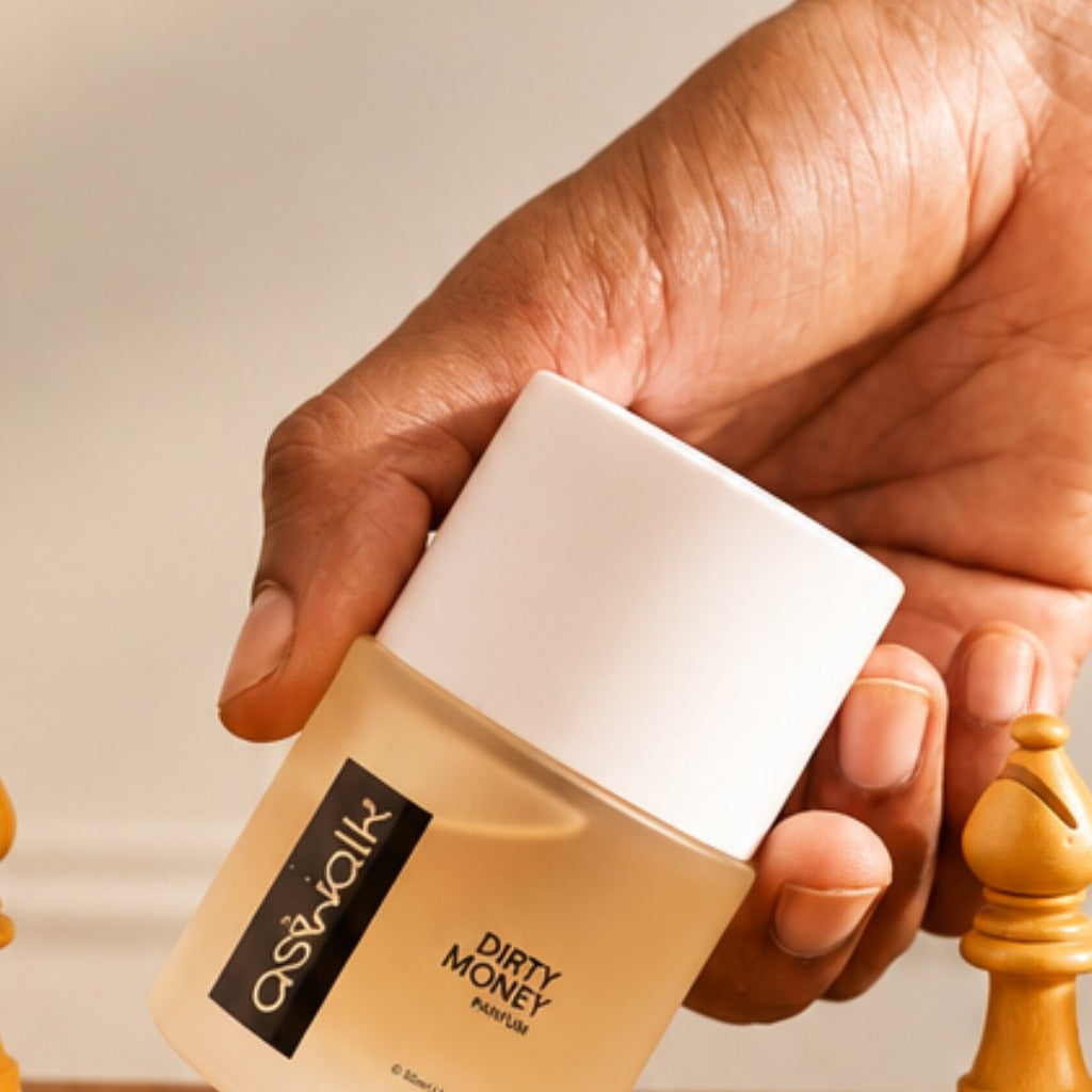 Dirty Money parfum bottle beside a chess piece